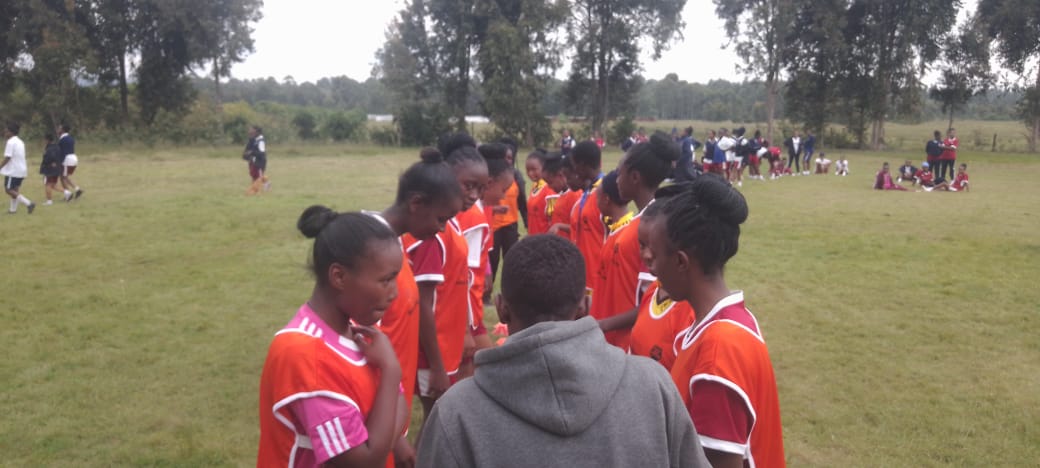 Students playing various sports in the field